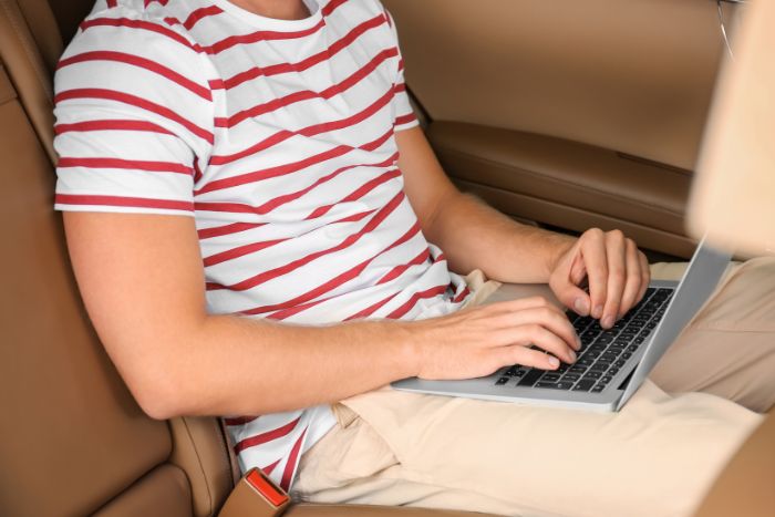 boy on computer on a road trip